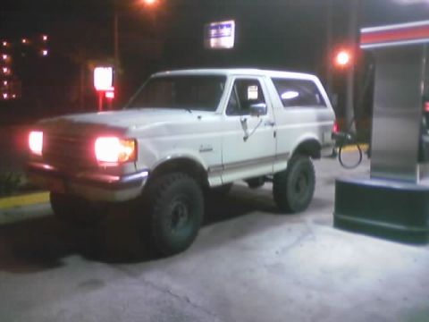 1989 Ford Bronco - This 1989 Ford Bronco is seen at a gas station, likely during nighttime hours.