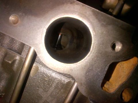 1994 Ford Bronco - Close-up view of an engine's cylinder head, showing a valve within a port.