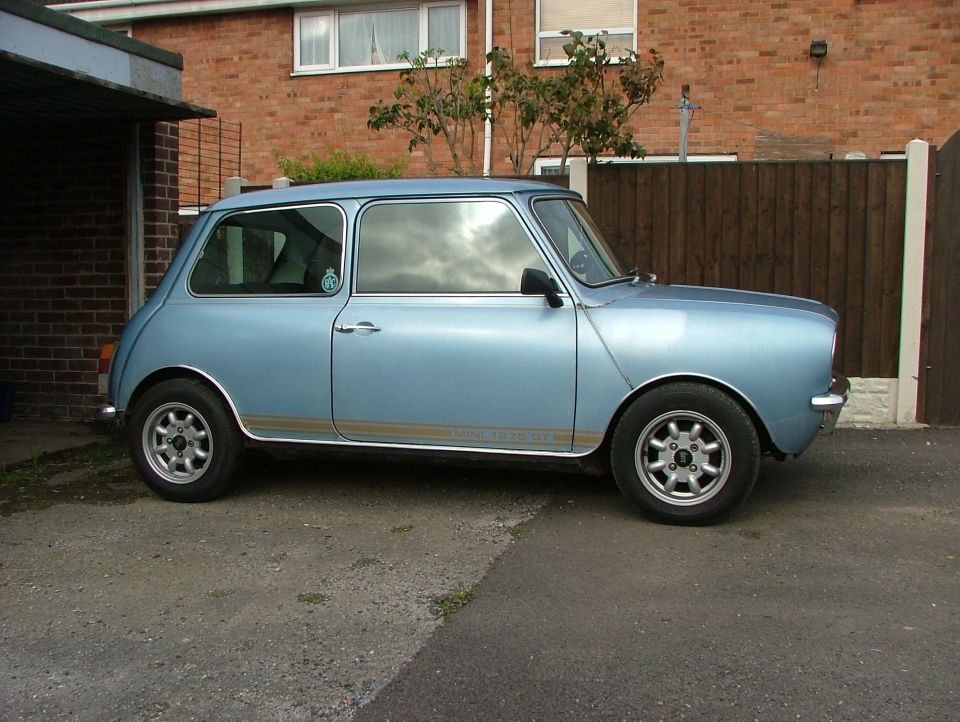Light blue 1980 MINI Cooper side view with gold stripe