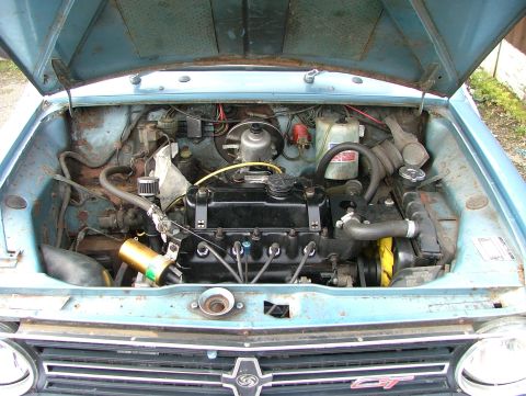 1980 MINI Cooper - The engine bay of a classic car is shown with the hood open, revealing the engine and surrounding components.