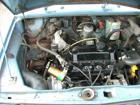 1980 MINI Cooper - The engine bay of a classic car reveals its mechanical components and signs of age.