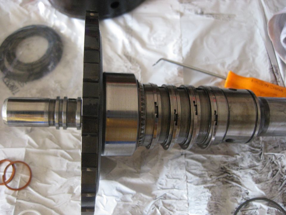 The nylon seals are removed and the steel ones have been unclipped. To unclip them push down at one end and at the opposite side of the shaft. This should raise one end higher than the other and allow it to unhook. If it will not come up enough to unhook a pick can be used to pull it up higher. Just be careful not to scratch the shaft.