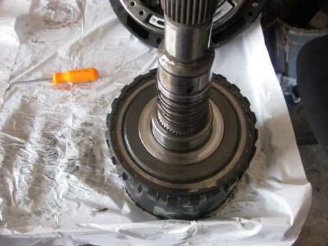 1994 Ford Bronco - The output shaft is carefully placed into the direct clutch drum and drive shell and a snap ring holds the output shaft to the drive shell.