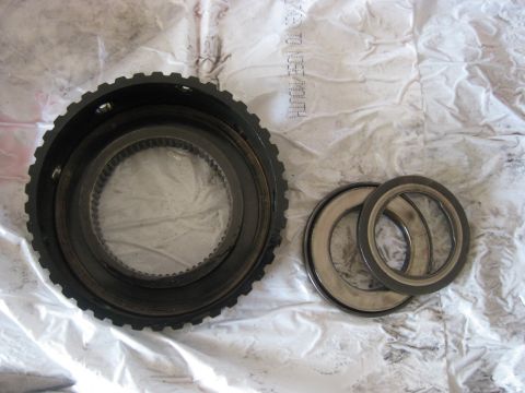 1994 Ford Bronco - This hub and bearing, washer are installed next. First the washer (far right) then the bearing (middle) and the hub (left). They must be in…