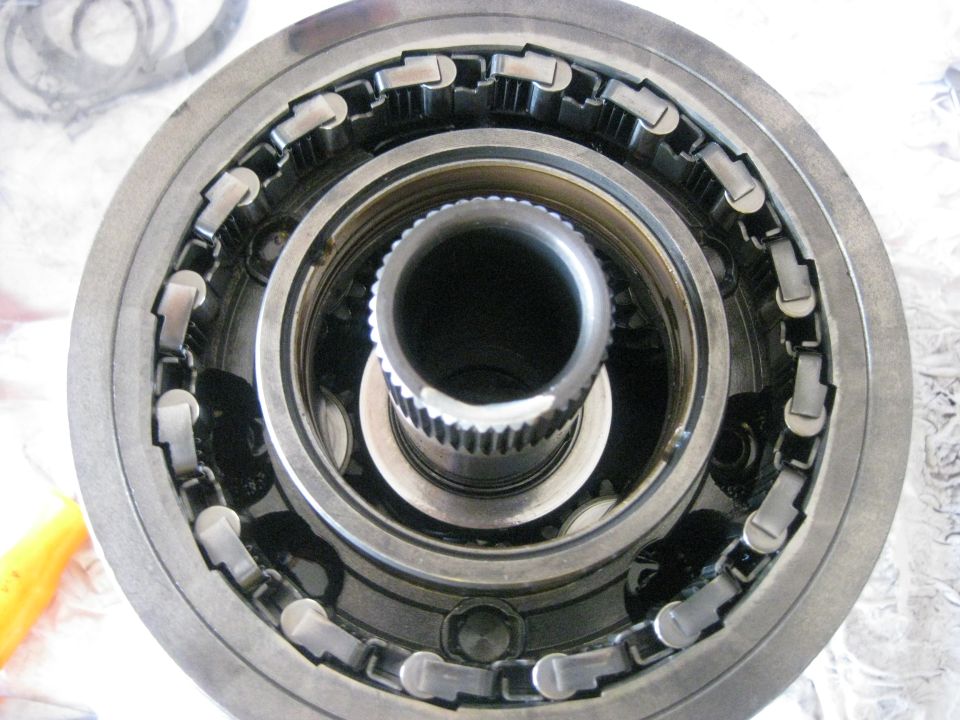 The planetary gearset does not need to be disassembled unless the bushings are bad. Aside from the sun gear (center)  and bushings this is as much as you can take apart.The one way roller clutch is visible here. It is the mechanical piece along the inside edge of the housing.