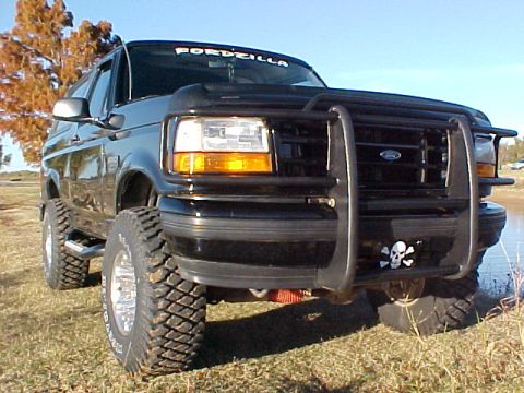 1995 Ford Bronco - This 1995 Ford Bronco is parked outdoors near a body of water.