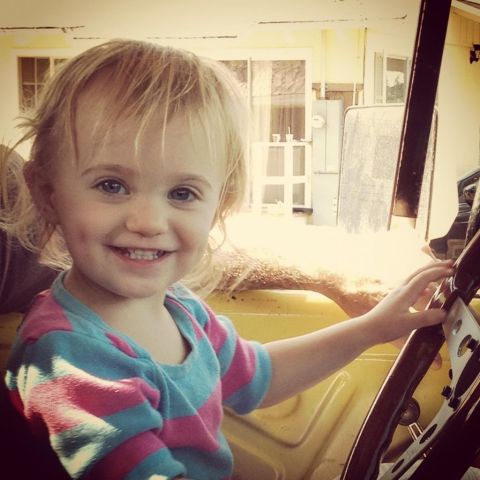 1978 Ford Bronco - Young child enjoys a moment behind the wheel of a vehicle.