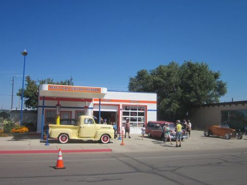 1991 Ford LTD Crown Victoria - Classic vehicles gather at Pete's Gas Station Museum under a clear blue sky.