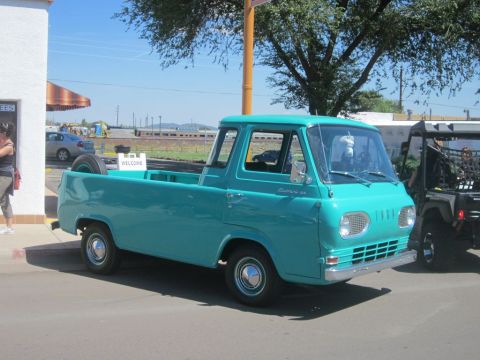1991 Ford LTD Crown Victoria - Turquoise 1961 Ford Econoline pickup truck seen at a car show with another vehicle nearby.