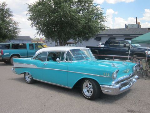 1991 Ford LTD Crown Victoria - A classic turquoise and white Chevrolet Bel Air is parked at an outdoor car show with other vehicles in the background.