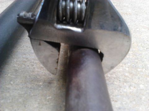 1996 Ford Bronco - Comparison of thickness of the driver side Inner Tie Rods. The wrench shows the thickness of the new rod over the old. The new rod has a th…