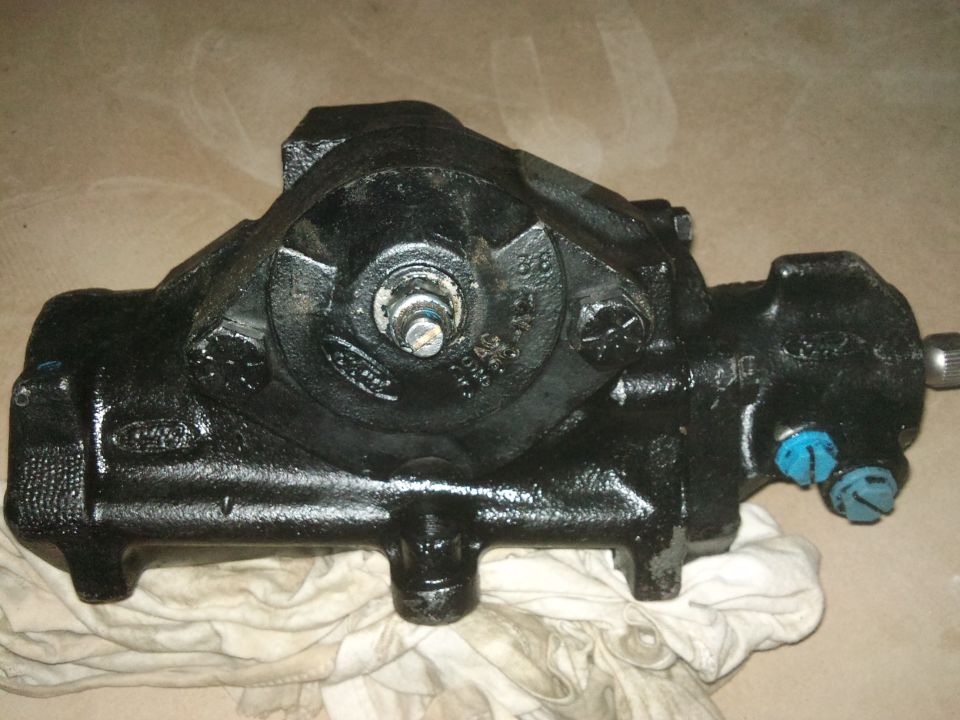 Black steering gear assembly with visible Ford logo and part numbers