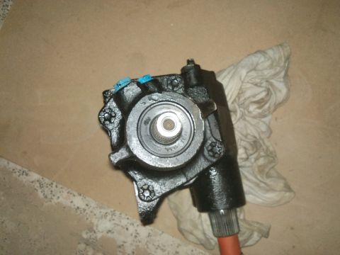 1998 Ford Crown Victoria - A close-up view of a steering gear assembly, likely a replacement part, resting on a cloth.