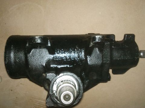 1998 Ford Crown Victoria - Close-up of a black steering gear component, showing cast-in text and a splined shaft.