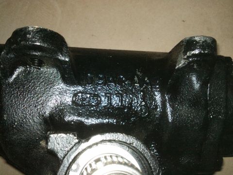 1998 Ford Crown Victoria - Close-up of a black metal steering gear housing, showing casting marks and a bearing assembly.