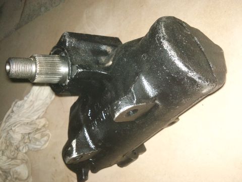 1998 Ford Crown Victoria - A black steering gear box with a splined shaft is shown in this close-up view.