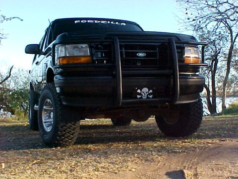 1995 Ford Bronco - This black Ford Bronco is equipped with a heavy-duty bull bar and a skull decal on the front bumper.