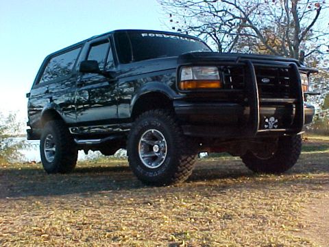 1995 Ford Bronco - This black 1995 Ford Bronco features a prominent bull bar with a skull decal on the front grille.