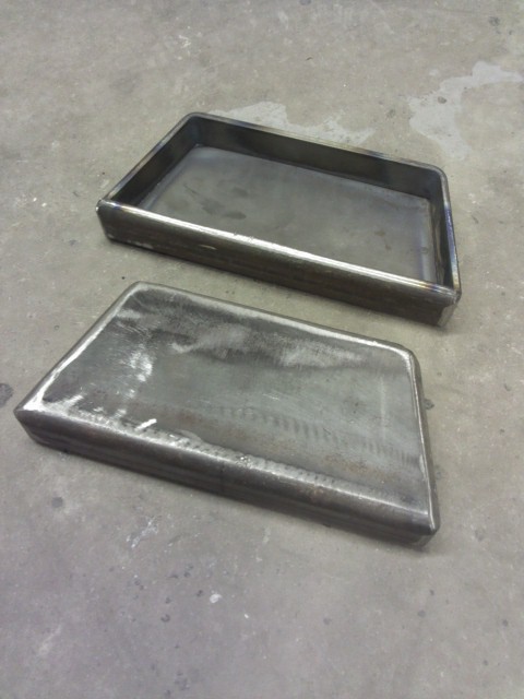 1993 Ford F-150 - Two custom-fabricated metal trays sit on a concrete surface, likely for automotive or industrial use.