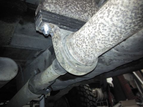 1993 Ford F-150 - Close-up of the driveshaft and exhaust system components on a vehicle.