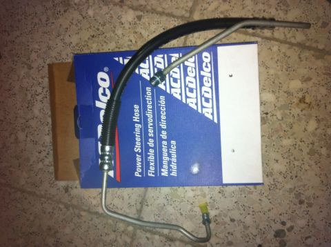 1998 Ford Crown Victoria - A power steering hose and its ACDelco packaging are shown, with text in English and Spanish.