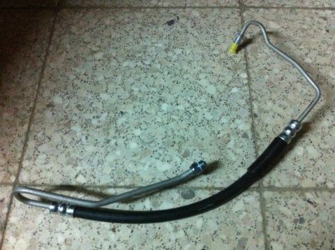 1998 Ford Crown Victoria - A power steering hose assembly is shown, metal tubing and a flexible black rubber hose section.