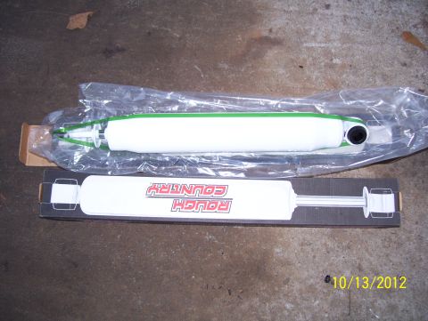 1990 Ford Bronco - Two shock absorbers are displayed, one in packaging and one in its original box.
