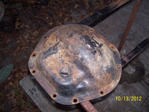 1990 Ford Bronco - A rusty differential cover is shown, with a date stamp and website visible in the lower right corner.