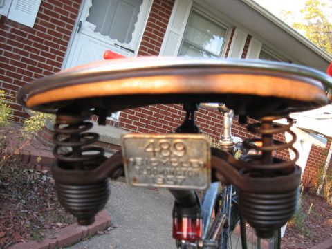1994 Ford Bronco - A vintage bicycle seat with prominent springs is shown, a license plate dated 1957.