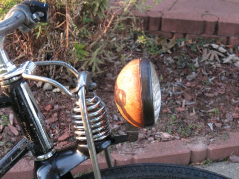 1994 Ford Bronco - Vintage bicycle headlight and handlebars with a rusty lens.