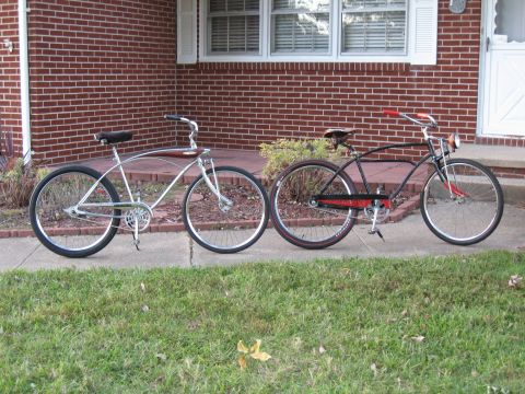 1994 Ford Bronco - Two vintage-style bicycles are displayed side-by-side on a sidewalk, with a brick house in the background.