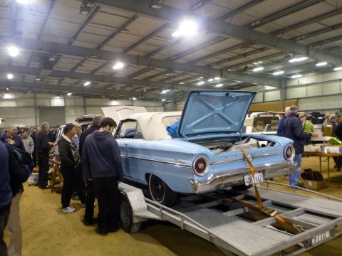 1969 Lincoln Continental - A light blue 1961 Ford Falcon convertible is displayed on a trailer with its trunk and hood open.