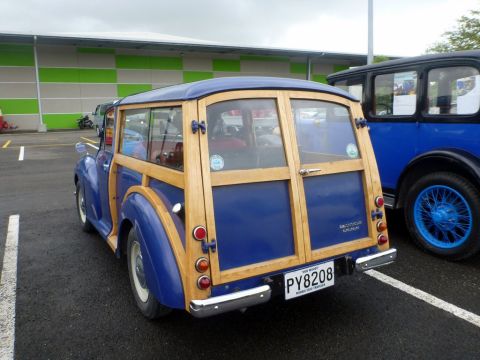 1969 Lincoln Continental - A blue woody wagon with distinctive wood paneling is parked next to a dark blue vintage car.