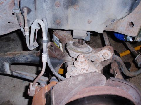 1995 Ford Bronco - Rusty suspension components are visible in this close-up view of a vehicle's undercarriage.