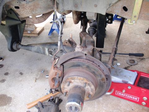 1995 Ford Bronco - The photo shows a close-up view of a vehicle's suspension and brake components, likely during maintenance or after maintenance.