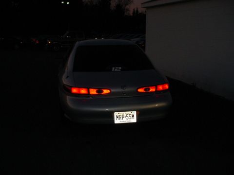 1999 Mercury Sable - The rear of a sedan is visible at night, with its taillights illuminated.
