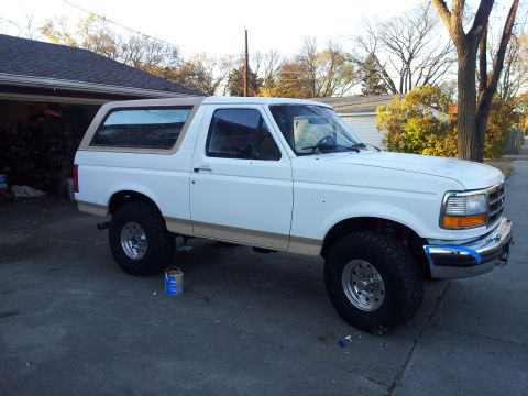 1996 Ford Bronco - This 1996 Ford Bronco is shown in a 3/4 front view, parked in a driveway.