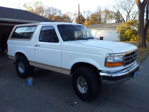 1996 Ford Bronco - This 1996 Ford Bronco is shown in a three-quarter front view, parked outside a residential garage.