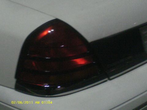 1998 Ford Crown Victoria - Close-up of the red taillight assembly on a white 1998 Ford Crown Victoria.