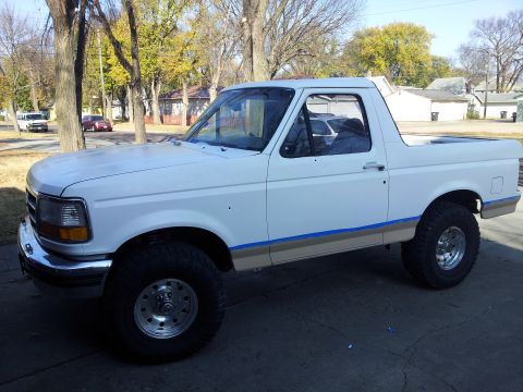 1996 Ford Bronco - This white Ford Bronco is shown from the front three-quarter view, parked outdoors on a paved surface.