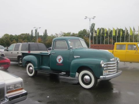 1991 Ford LTD Crown Victoria - Green 1950 Chevrolet pickup truck with whitewall tires and a circular emblem on the door.