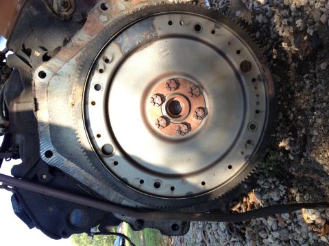1987 Ford Ranger - Close-up of an engine flywheel and bell housing, showing bolted connection and gear teeth.