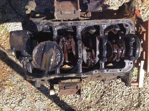 1987 Ford Ranger - Disassembled engine block with internal components exposed, sitting outdoors on a gravel surface.