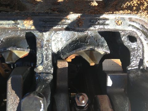 1987 Ford Ranger - Close-up view of severely damaged engine crankshaft bearings, indicating significant wear and potential failure.