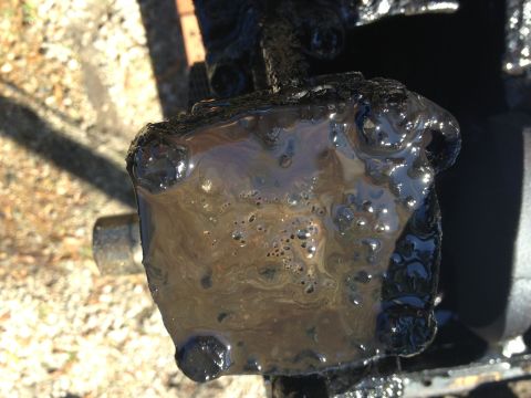 1987 Ford Ranger - This greasy metal part shows signs of bubbling, possibly indicating an issue with fluid or heat.
