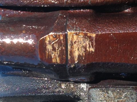 1987 Ford Ranger - Close-up of a rusty engine part showing scratched markings. The registry claims it is from a 1987 Ford Ranger, but this cannot be confirmed…