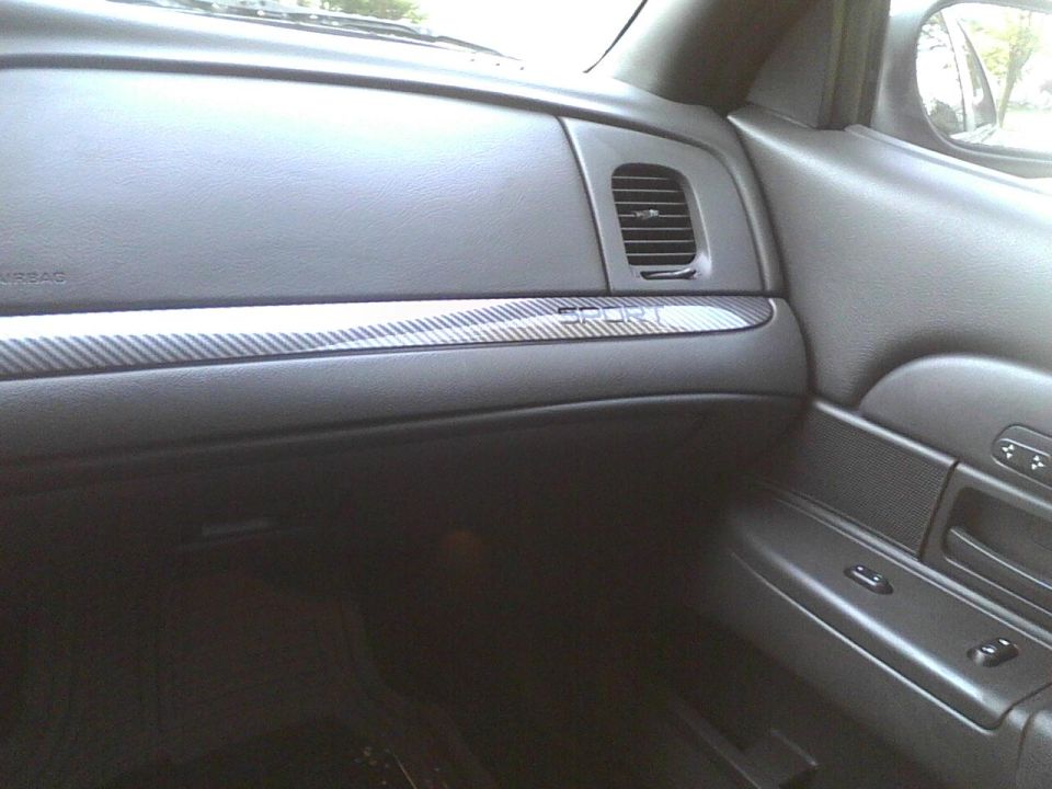 Interior shot of a car's dashboard, showing the passenger side air vent and trim. Text on the trim reads 'SPORT'
