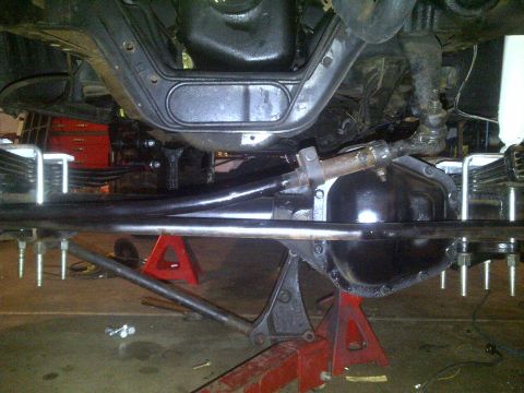 1995 Ford Bronco - Close-up view of the undercarriage and suspension components of a vehicle, likely undergoing maintenance or modification.