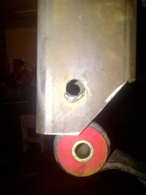 1995 Ford Bronco - A close-up view of a vehicle's suspension component, likely a bracket and bushing.