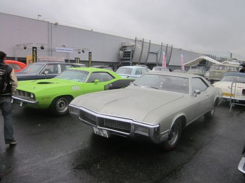 1991 Ford LTD Crown Victoria - A silver coupe from the late 1960s is displayed at an outdoor event with other vehicles.